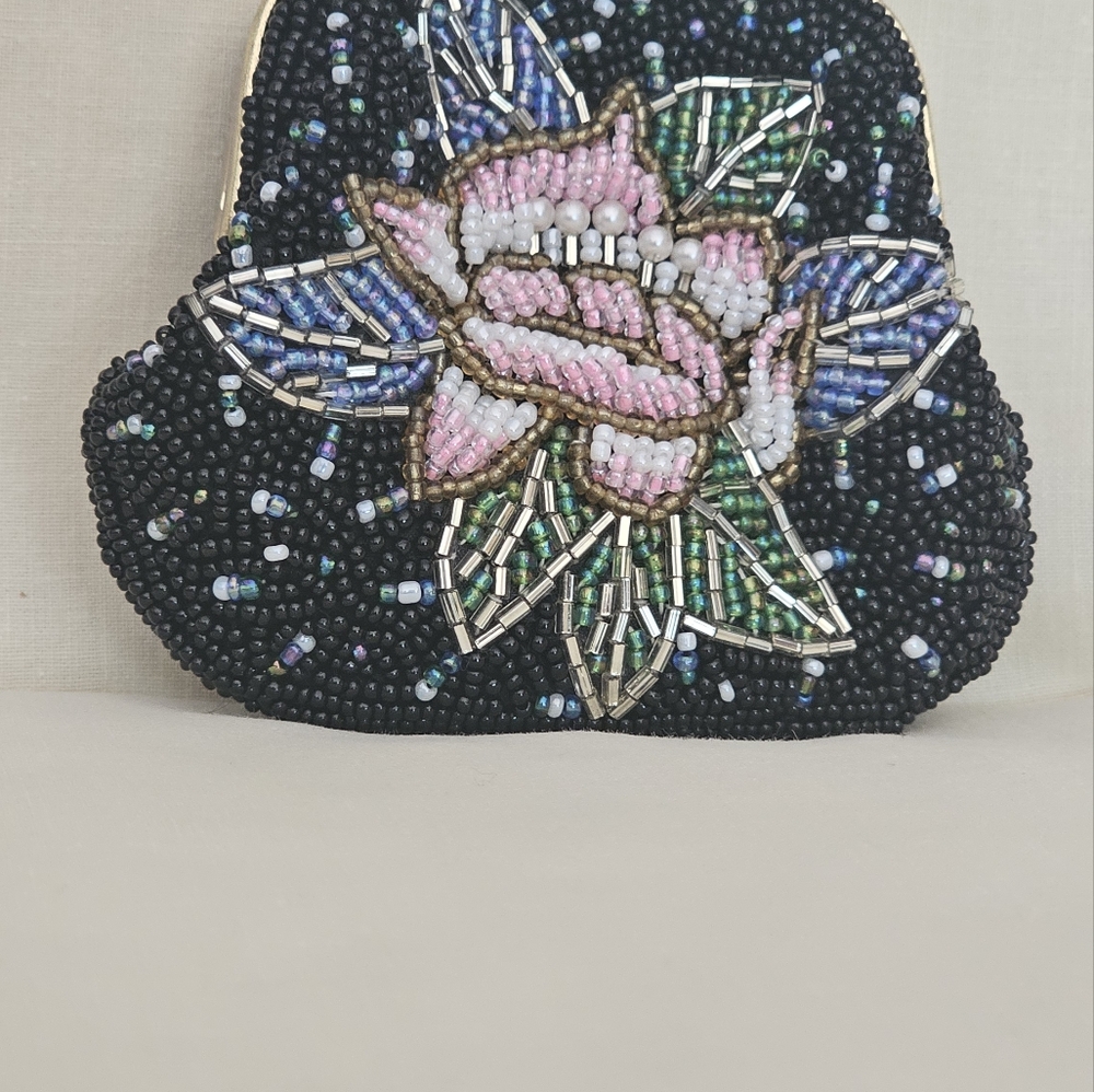 Beaded coin purse main color black like new never been used. 100% Viscose